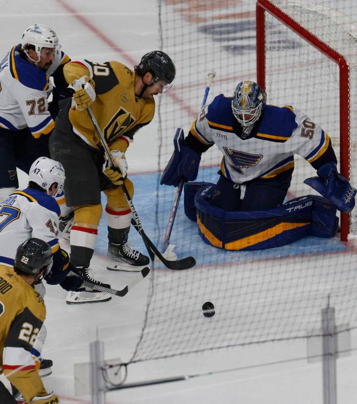 Golden Knights center Chandler Stephenson (20) tries to shoot against St. Louis Blues goaltende ...
