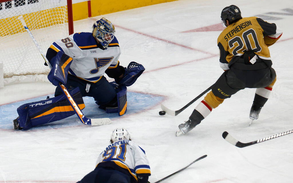 Golden Knights center Chandler Stephenson (20) tries to shoot against St. Louis Blues goaltende ...