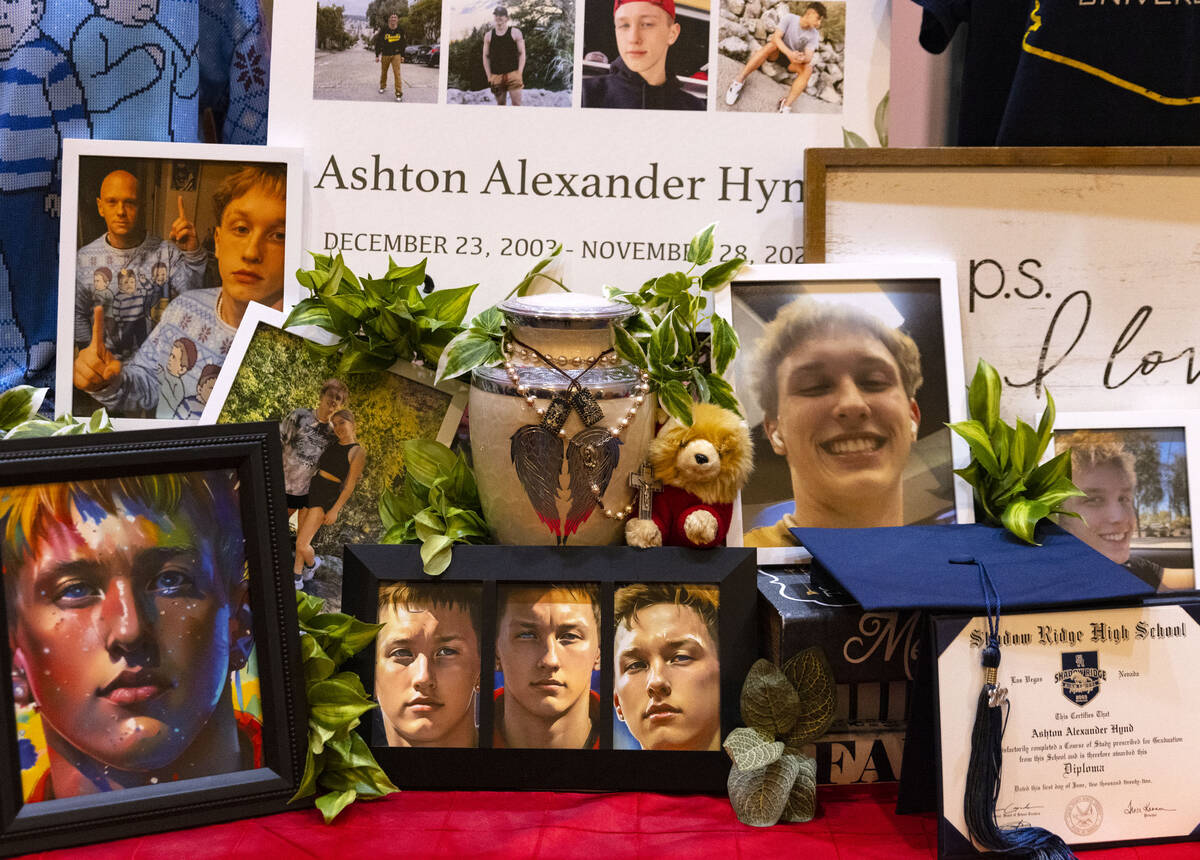 Photographes of Ashton Hynd are displayed during a memorial service at Palm Northwest Mortuary ...