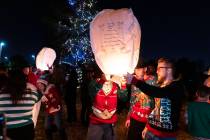 Family members and friends gathered to release sky lanterns after a memorial service at Palm No ...