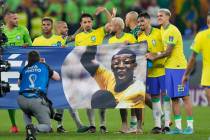 Brazil's players shows a banner in support of Brazilian soccer legend Pele at the end of the Wo ...