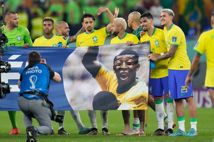 Brazil's players shows a banner in support of Brazilian soccer legend Pele at the end of the Wo ...