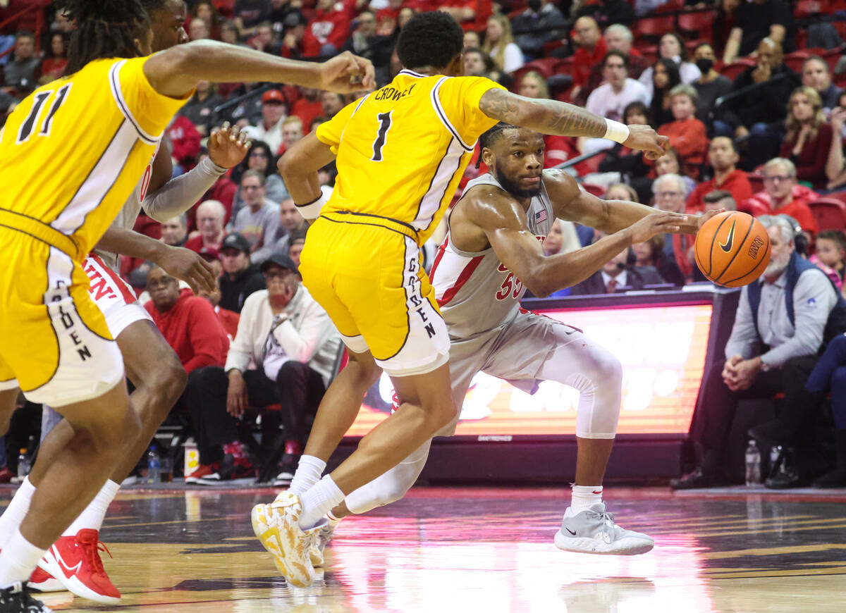 UNLV Rebels guard EJ Harkless (55) drives the ball under pressure from Southern Miss Golden Eag ...