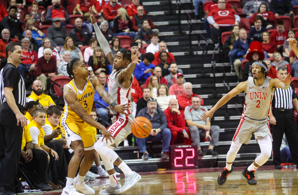 Southern Miss Golden Eagles guard Mo Arnold (3) passes the ball around UNLV Rebels guard Keshon ...