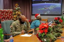 In this photo released by the U.S. Department of Defense, volunteers answer phones and emails f ...