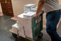 Stacks of the Congressional Record are distributed as lawmakers debate a massive $1.7 trillion ...