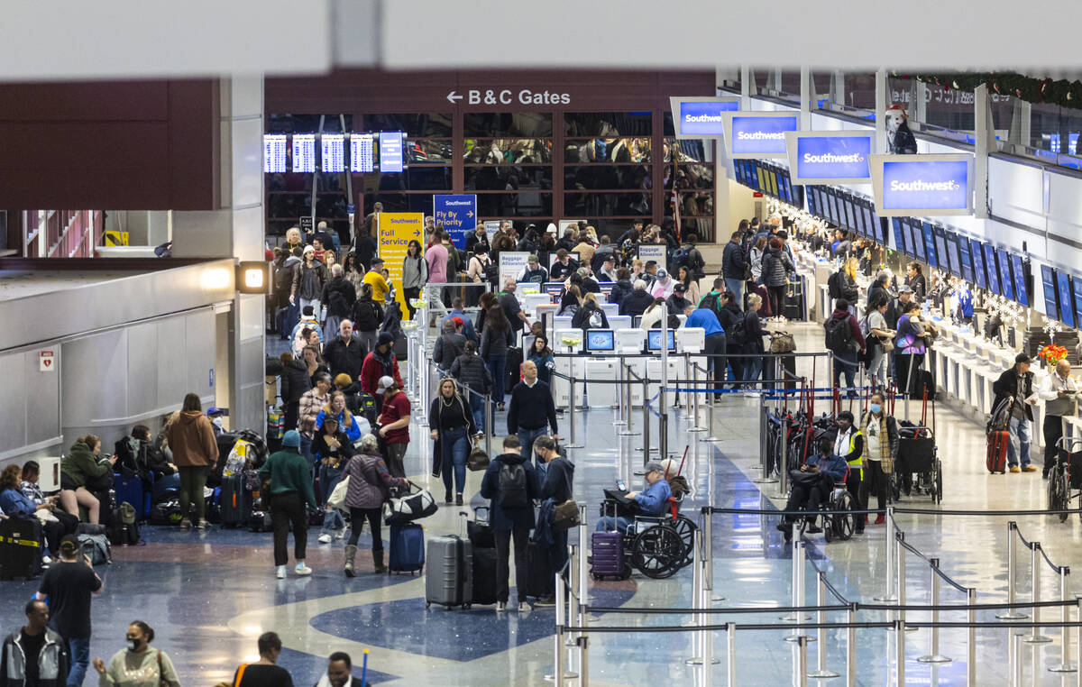 Passengers check-in at Southwest Airlines at Harry Reid International Airport on Thursday, Dec. ...