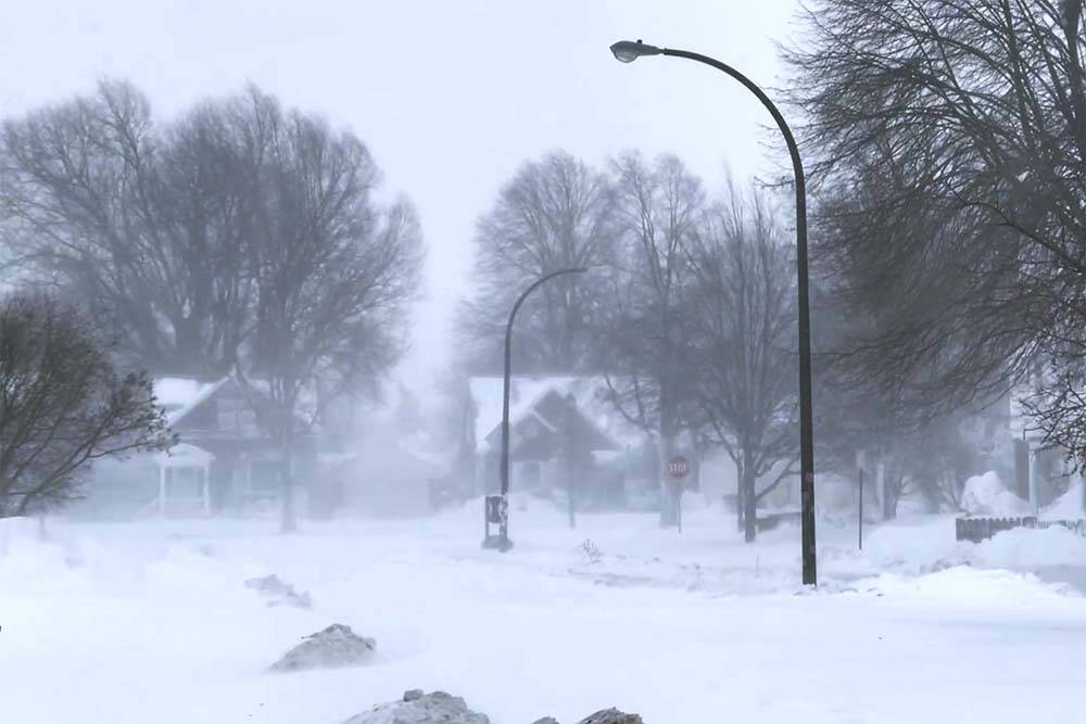 The high wind blows the snow across a neighborhood in Buffalo, N.Y., on Saturday, Dec. 24, 2022 ...