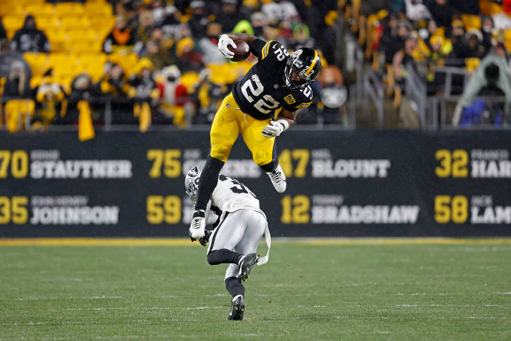Pittsburgh Steelers running back Najee Harris (22) jumps over Las Vegas Raiders cornerback Nate ...