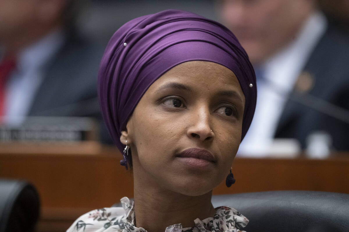 FILE - In this March 6, 2019, file photo, Rep. Ilhan Omar, D-Minn., sits with fellow Democrats ...
