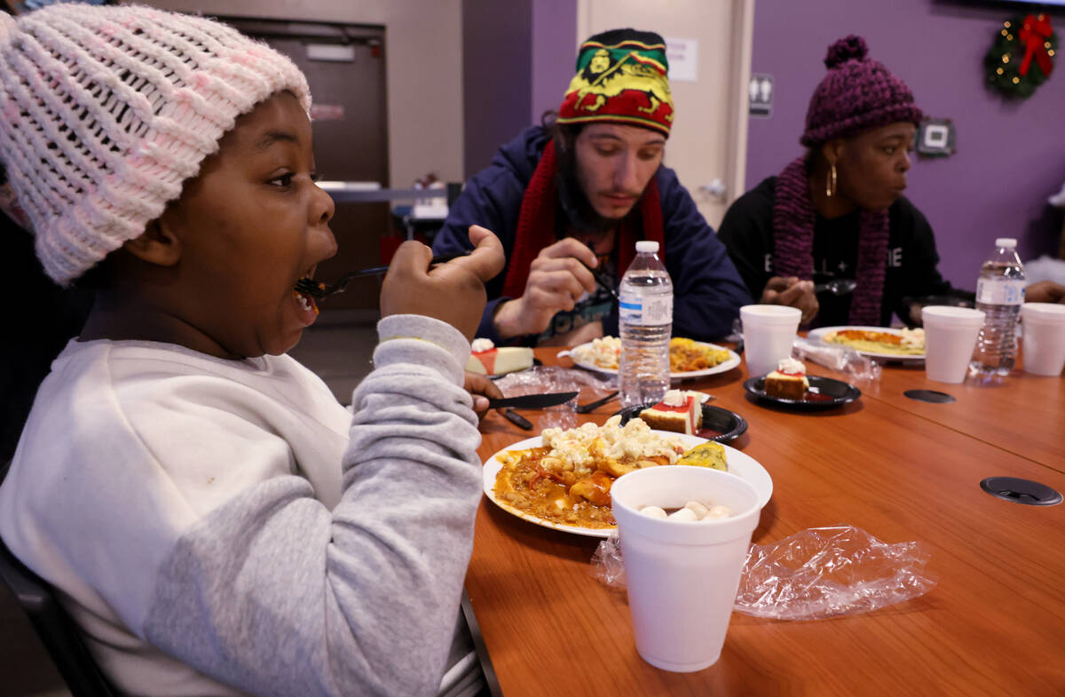 Jaylees Sims, 6, eats a Christmas meal at Catholic Charities of Southern Nevada in Las Vegas Su ...