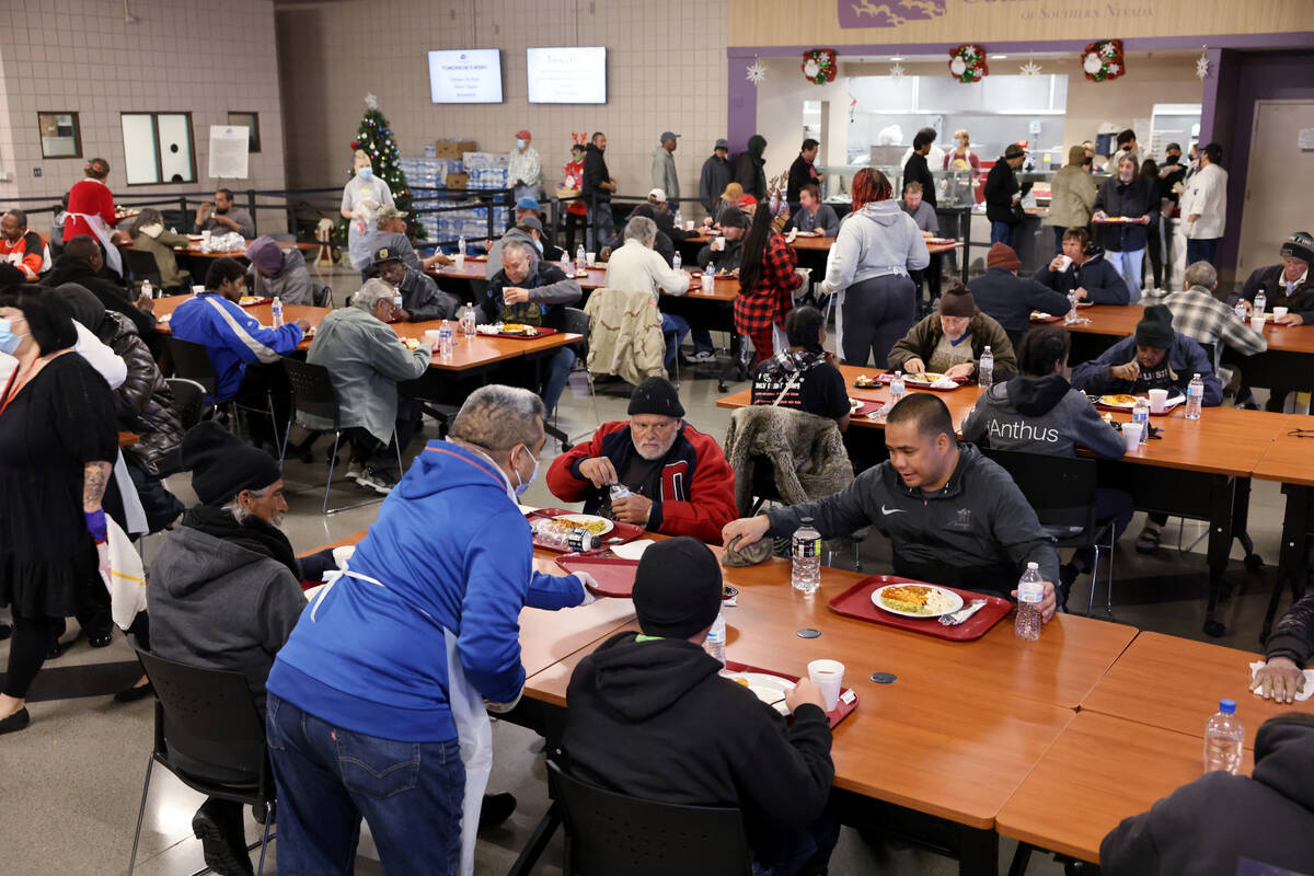 People eat a Christmas meal at Catholic Charities of Southern Nevada in Las Vegas Sunday, Dec. ...