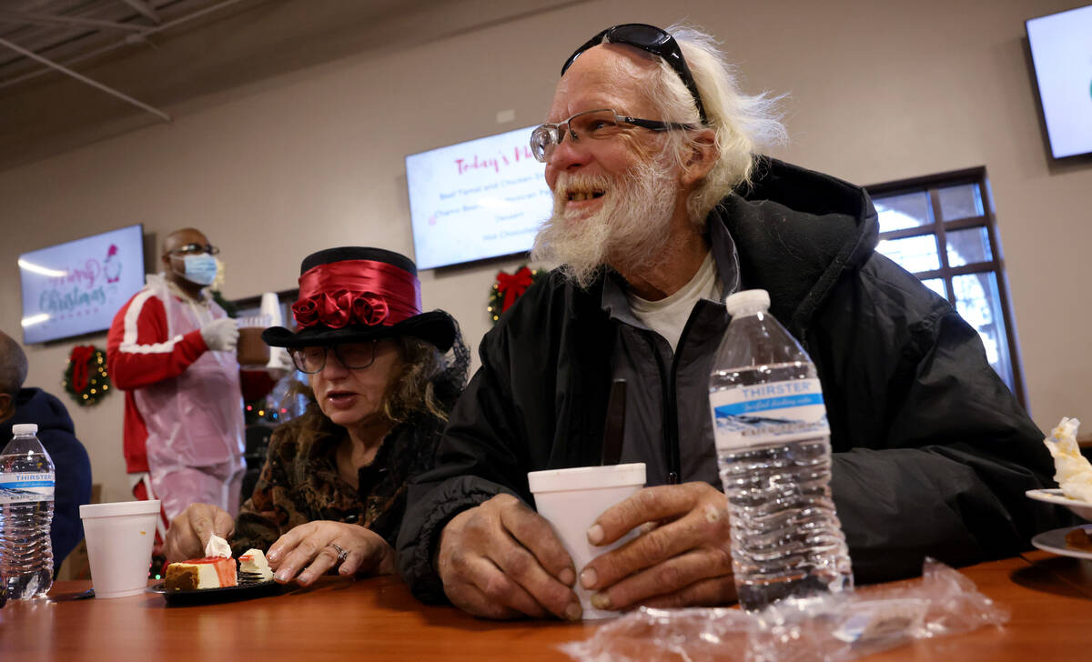 Mark Leo McCarthy, 60, and Patricia McCaigue, 73, eat a Christmas meal at Catholic Charities of ...