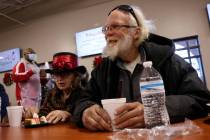 Mark Leo McCarthy, 60, and Patricia McCaigue, 73, eat a Christmas meal at Catholic Charities of ...