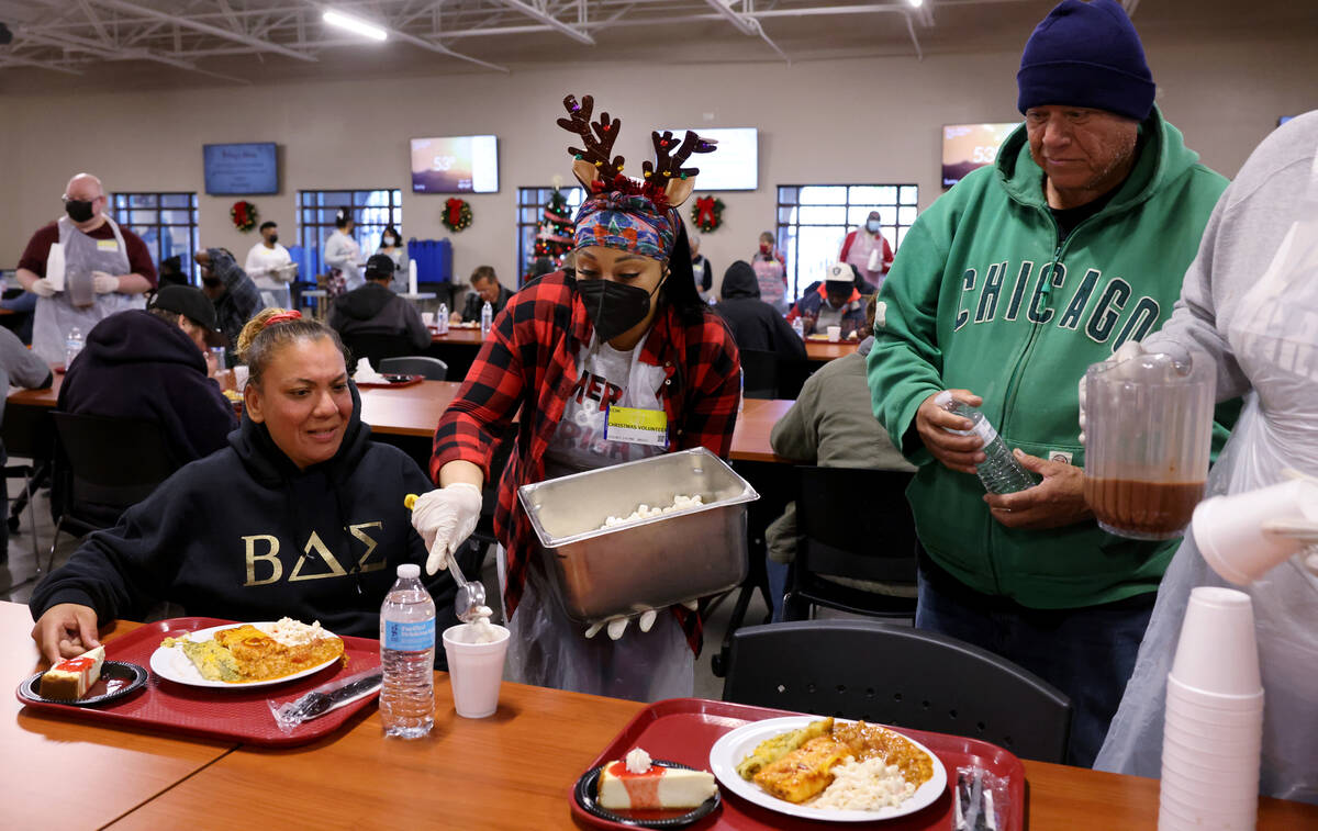 Aisha Johnson pours marshmallows into hot chocolate for Priscilla Vega and Jorge Gutierrez duri ...