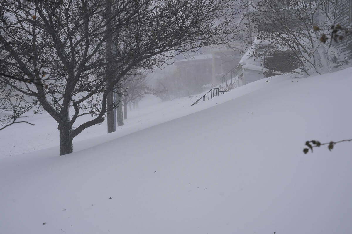 Snow drifts over the sidewalk on West Delavan Avenue in Buffalo, N.Y. on Saturday, Dec. 24, 202 ...