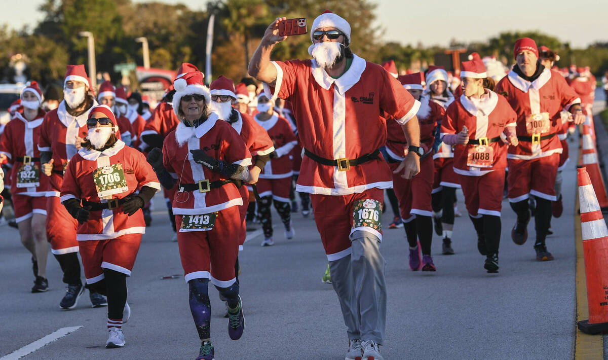 More than 800 runners dressed as Santa Claus braved near freezing temperatures to participate i ...