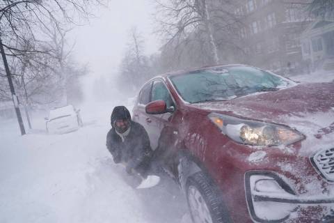 Gamaliel Vega tries to dig out his car on Lafayette Avenue after he got stuck in a snowdrift ab ...