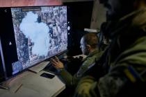 Ukrainian soldiers watch a drone feed from an underground command center in Bakhmut, Donetsk re ...