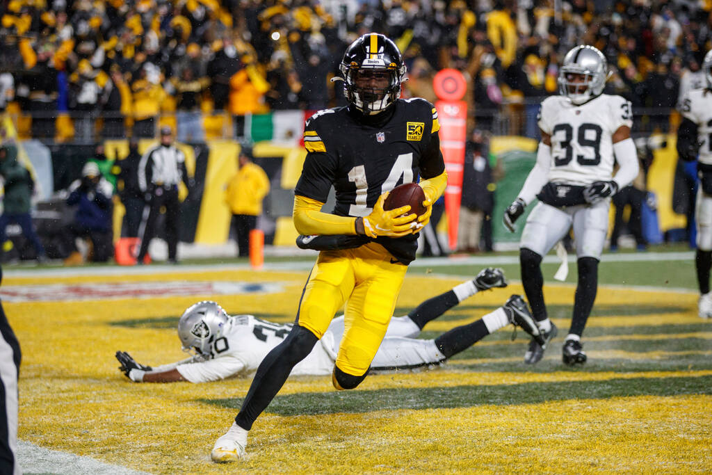 Pittsburgh Steelers wide receiver George Pickens (14) catches a touchdown pass during an NFL fo ...