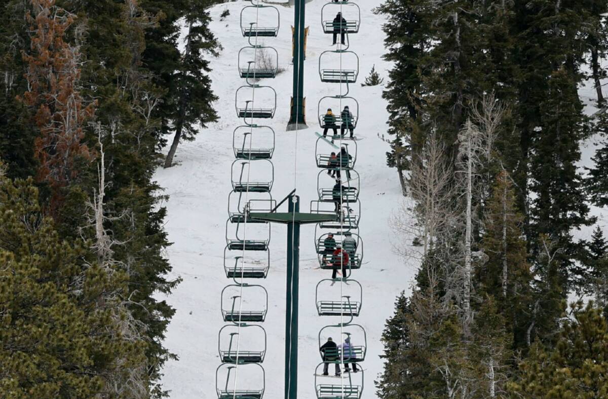 Skiers and snowboarders ride chairlifts, Monday, Dec. 26, 2022, at the Lee Canyon Ski and Snowb ...