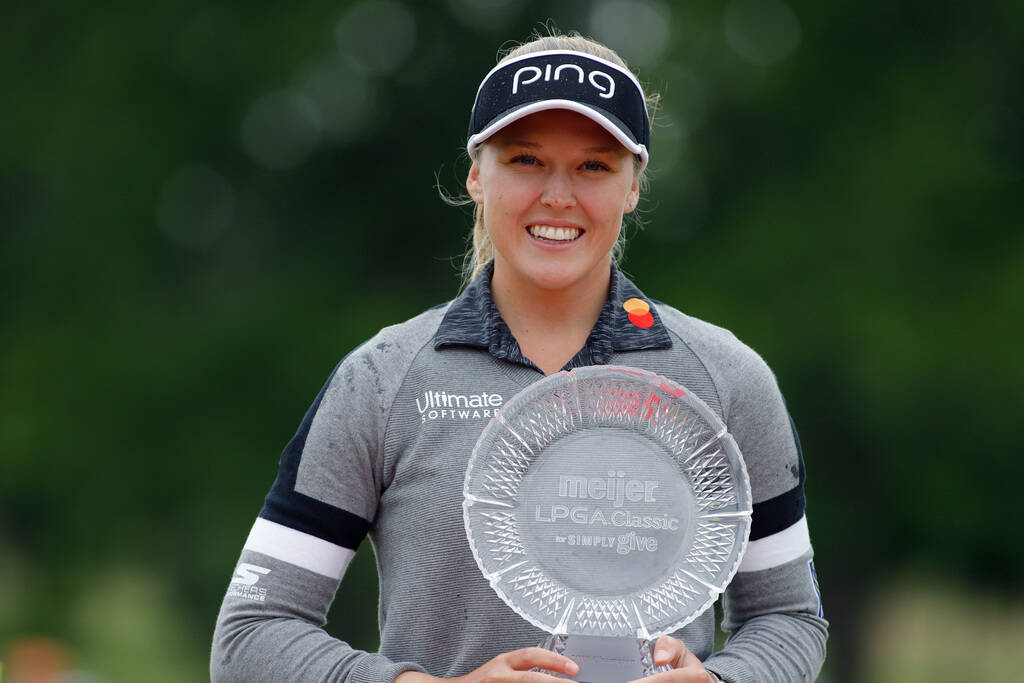 Brooke Henderson, of Canada, holds the championship trophy after winning the Meijer LPA Classic ...