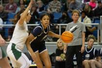 Charlece Ohiaeri of Centennial High School dribbles into Bishop Manogue defender Alyssa Premo d ...