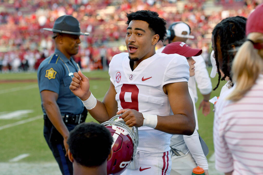 Alabama quarterback Bryce Young (9) talks to his team on the sidelines against Arkansas after l ...