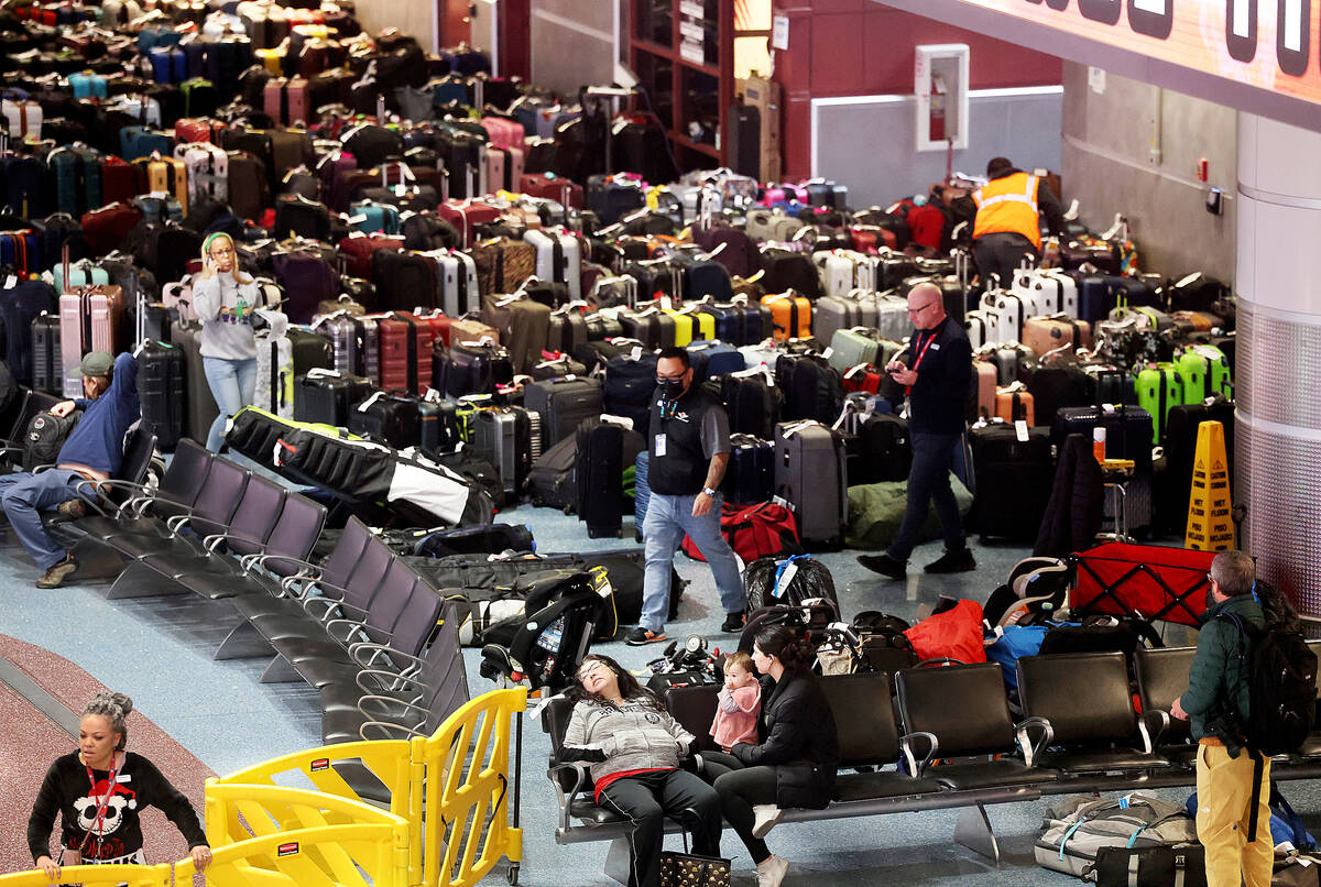 Workers looks for passengers’ luggage from canceled and delayed flights in the Southwest bagg ...