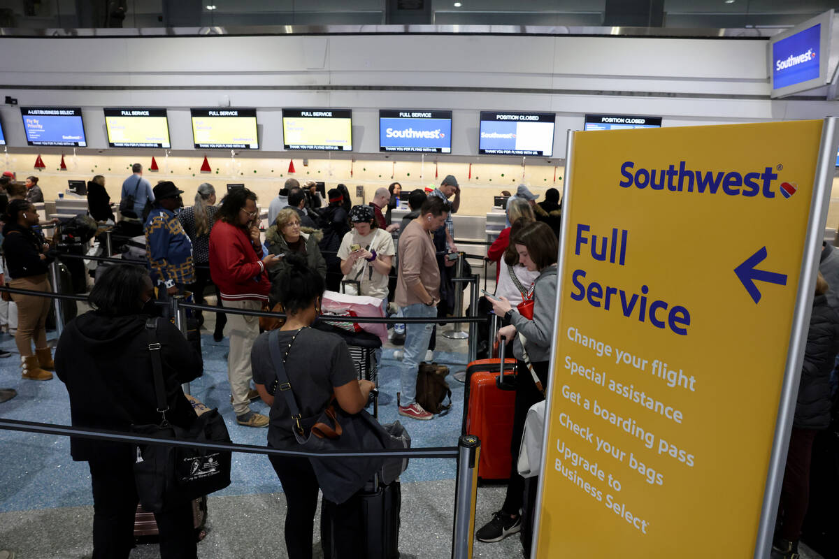 Passengers wait in line at the Southwest ticket counter in Terminal 1 at Harry Reid Internation ...