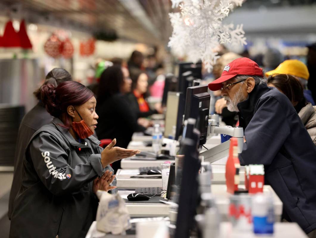 Agents help passengers at the Southwest ticket counter in Terminal 1 at Harry Reid Internationa ...