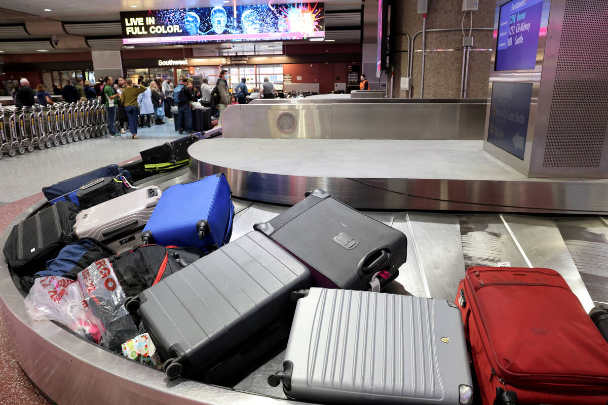 Luggage sits on a non-moving carousel from cancelled and delayed flights in the Southwest bagga ...