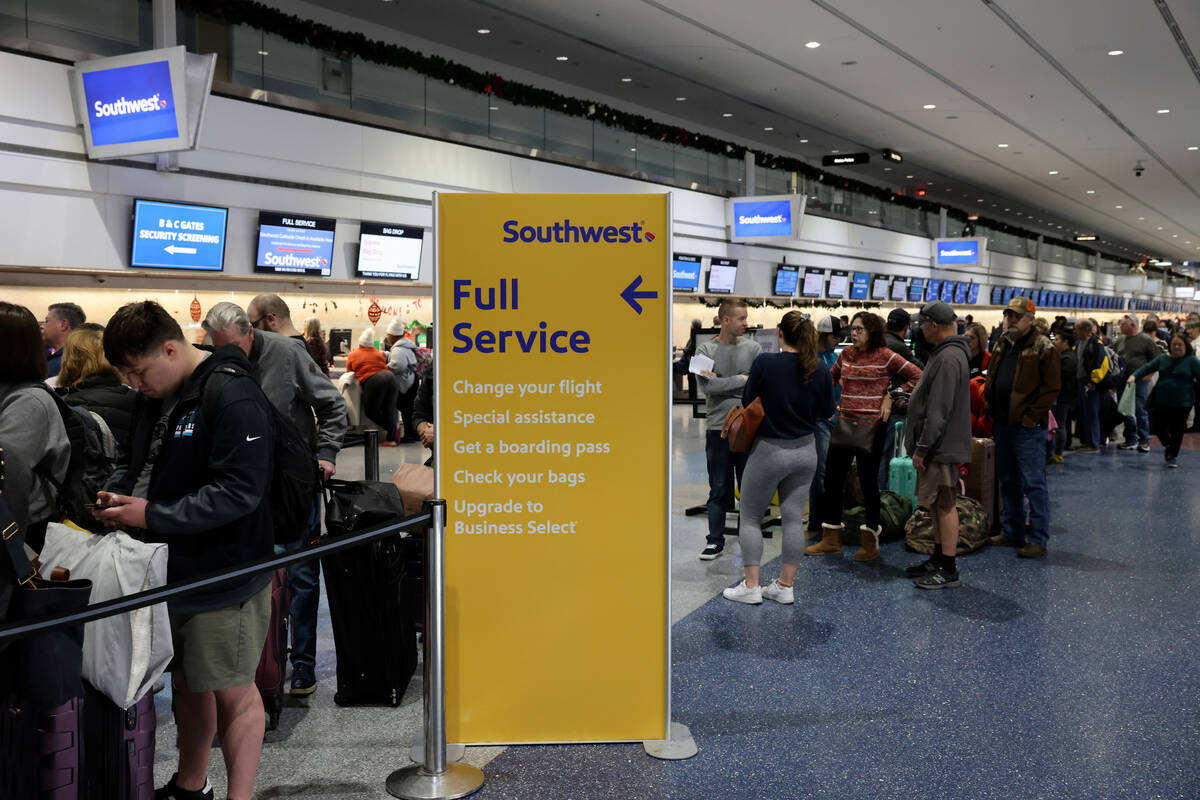 Passengers wait in line at the Southwest ticket counter in Terminal 1 at Harry Reid Internation ...