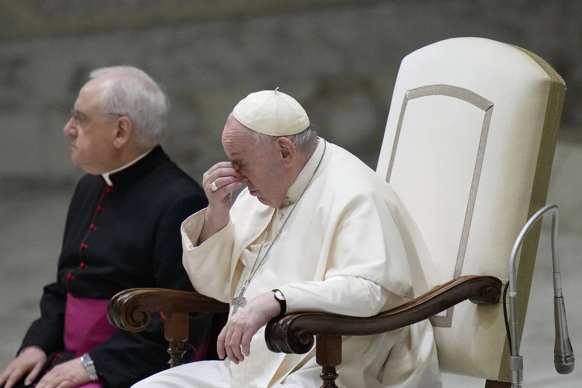 Pope Francis, right, sits next to Monsignor Leonardo Sapienza, left, as they attend the weekly ...