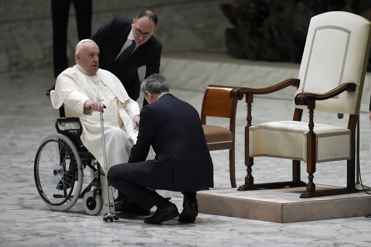 Pope Francis prepares to leave on a wheelchair at the end of his weekly general audience in the ...