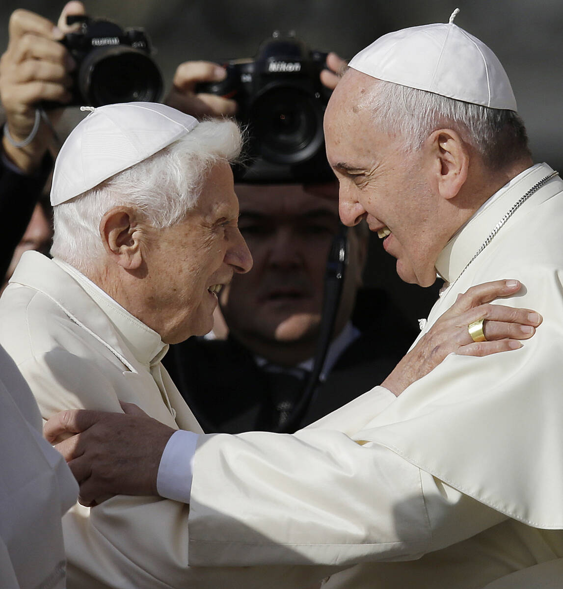 FILE - Pope Francis, right, hugs Pope Emeritus Benedict XVI prior to the start of a meeting wit ...