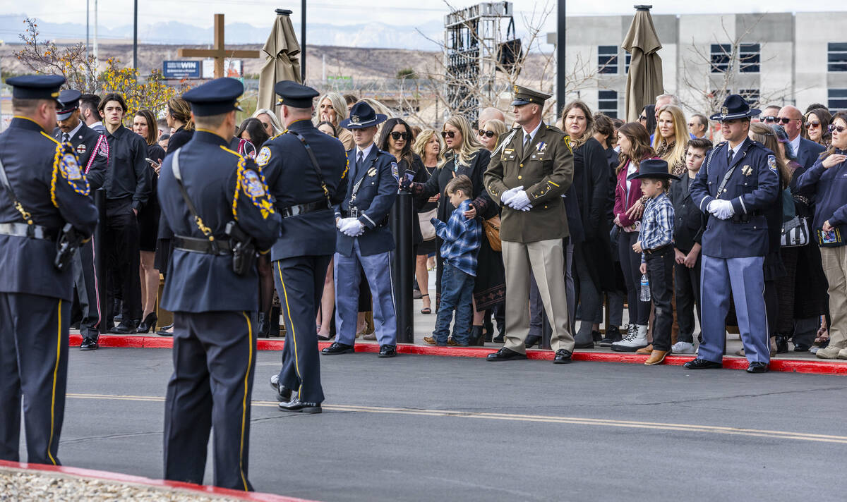 Mourners including family members and friends await the processional as Henderson Fire Departme ...