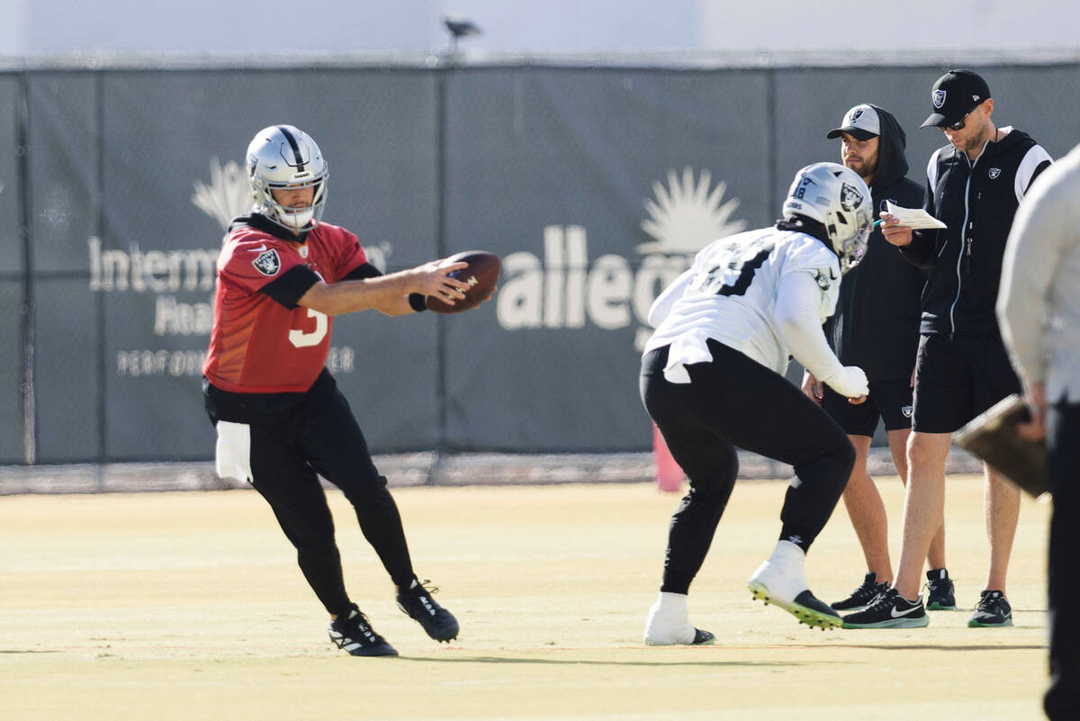 Raiders quarterback Jarrett Stidham (3) takes a snap from center Andre James (68) as offensive ...