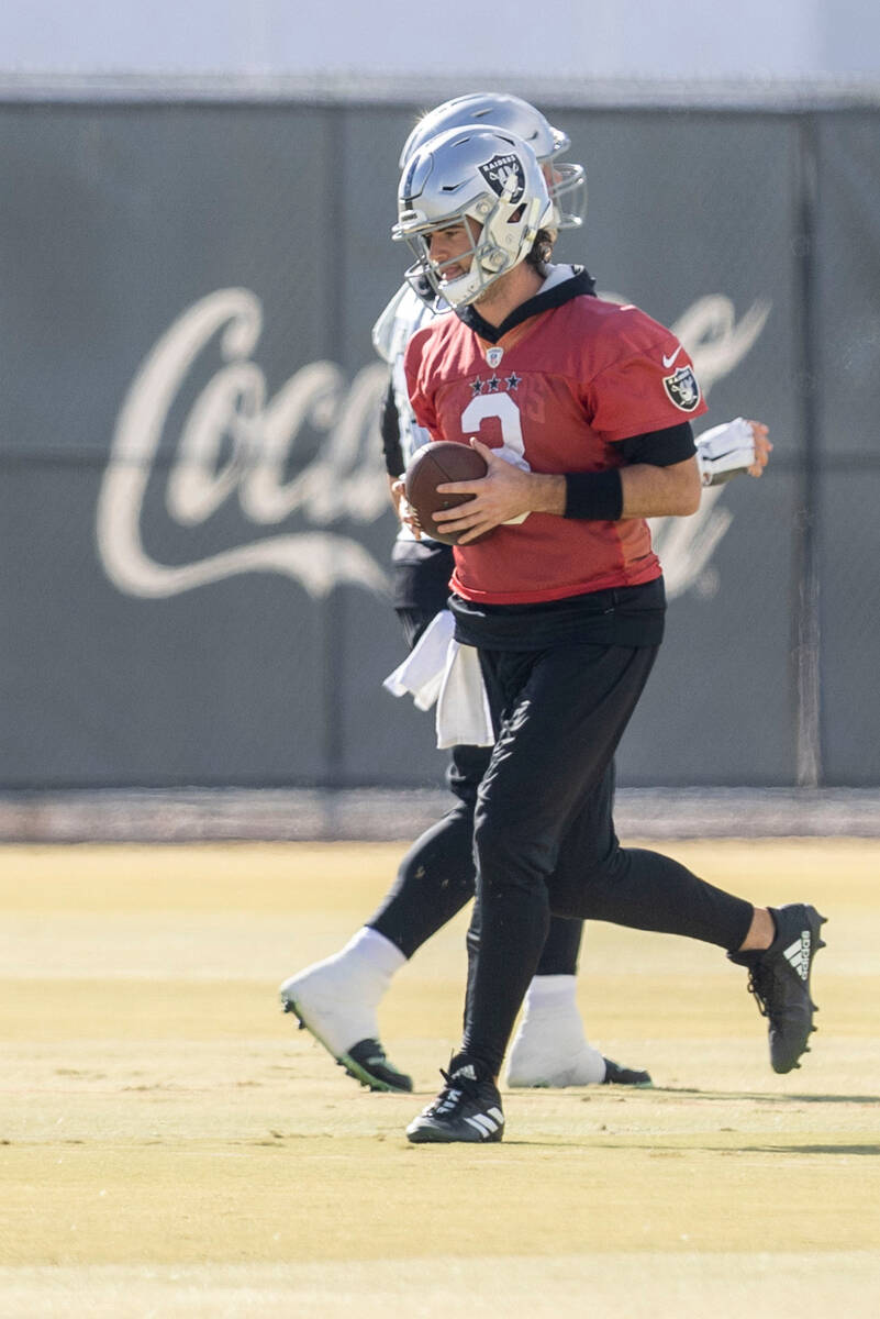 Raiders quarterback Jarrett Stidham (3) runs with the football during practice at the Intermoun ...