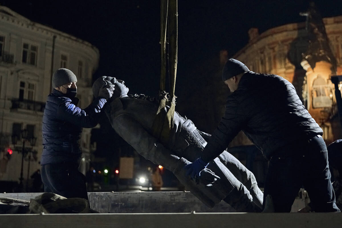 Workers remove part of the monument to Catherine II, also known as "Monument to the Founde ...