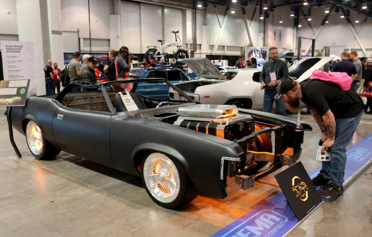 Mark Pagel of Oshkosh, Wis. checks out an all electric Mercury Cougar in the SEMA Electrified s ...