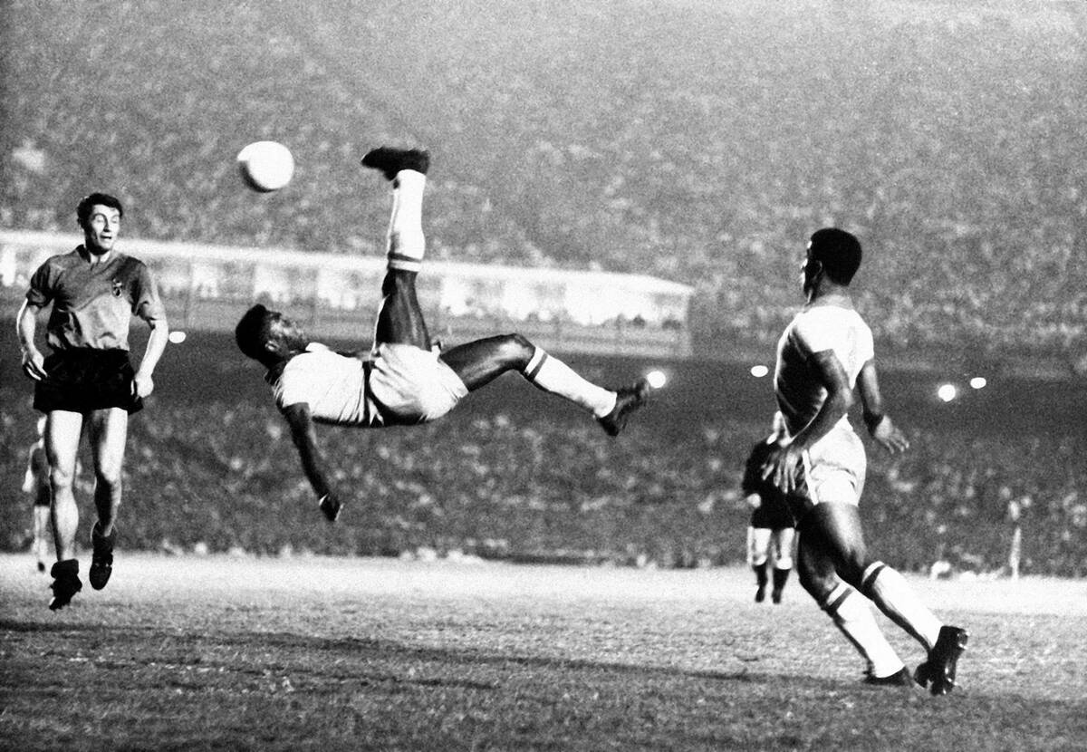 Brazil's soccer star Pele bicycle kicks a ball during a game at unknown location, Sept. 1968. ...