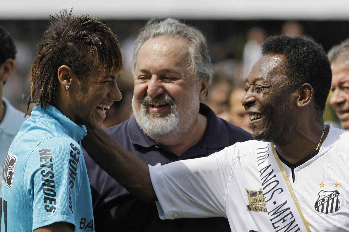 Soccer player Neymar, left, and Brazalian soccer legend Pele, share a laugh during a centennial ...
