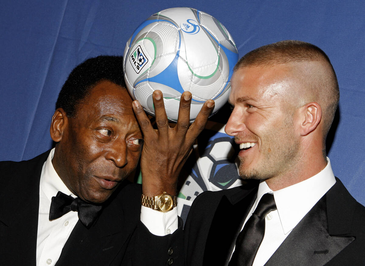 Brazilian soccer great Pele, and English soccer star David Beckham pose for photos during a U.S ...
