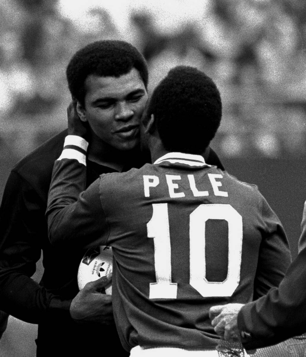 Soccer player Pele embraces boxer Muhammad Ali during a ceremony honoring the Brazilian soccer ...