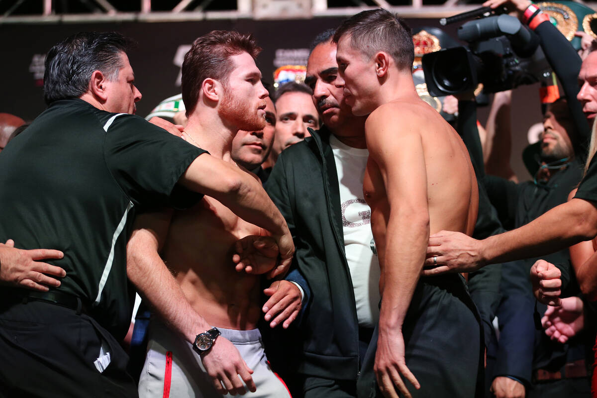 Saul "Canelo" Alvarez, left, and Gennady Golovkin pose during a weigh-in at T-Mobile Arena in L ...