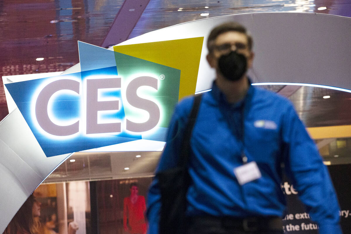 A convention attendee wears a mask to prevent the spread of COVID-19 during the third day of th ...