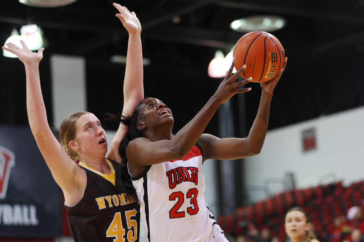 UNLV Lady Rebels center Desi-Rae Young (23) goes up for a shot under pressure from Wyoming Cowg ...