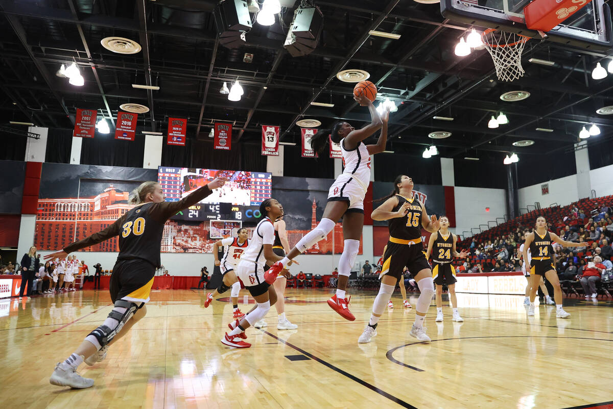 UNLV Lady Rebels center Desi-Rae Young (23) takes a shot at the basket as Wyoming Cowgirls forw ...