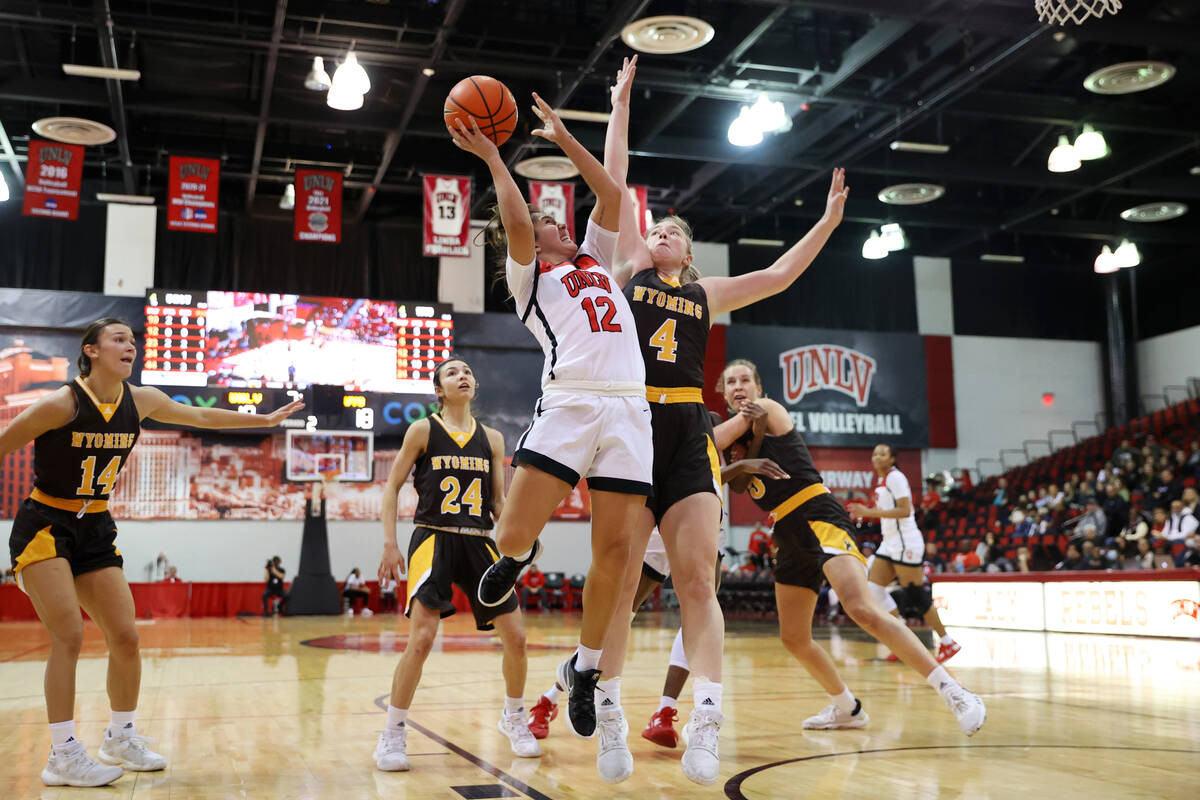 UNLV Lady Rebels guard Alyssa Durazo-Frescas (12) leaps for a shot under pressure from Wyoming ...